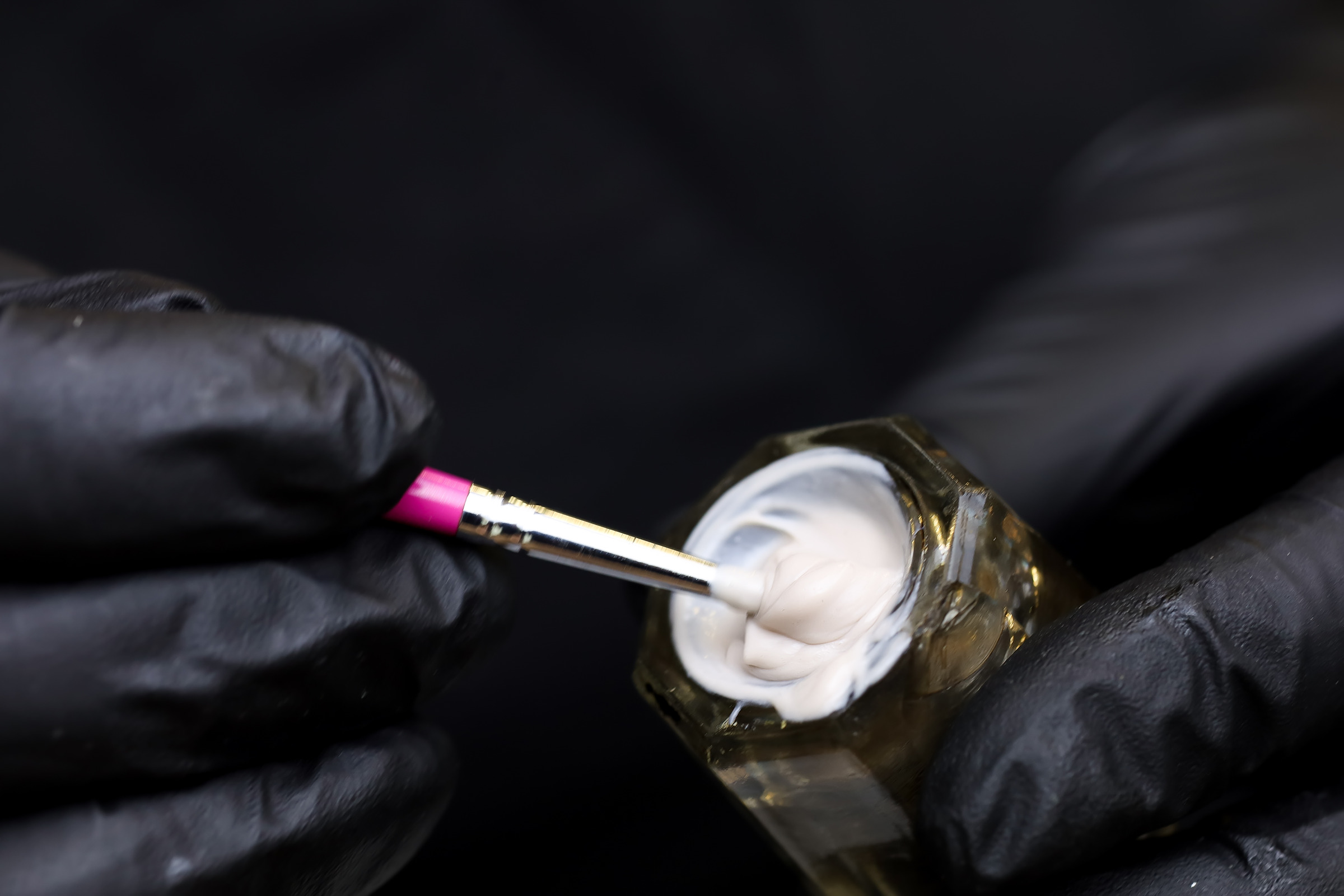 Close-up of brow lamination cream on a brush