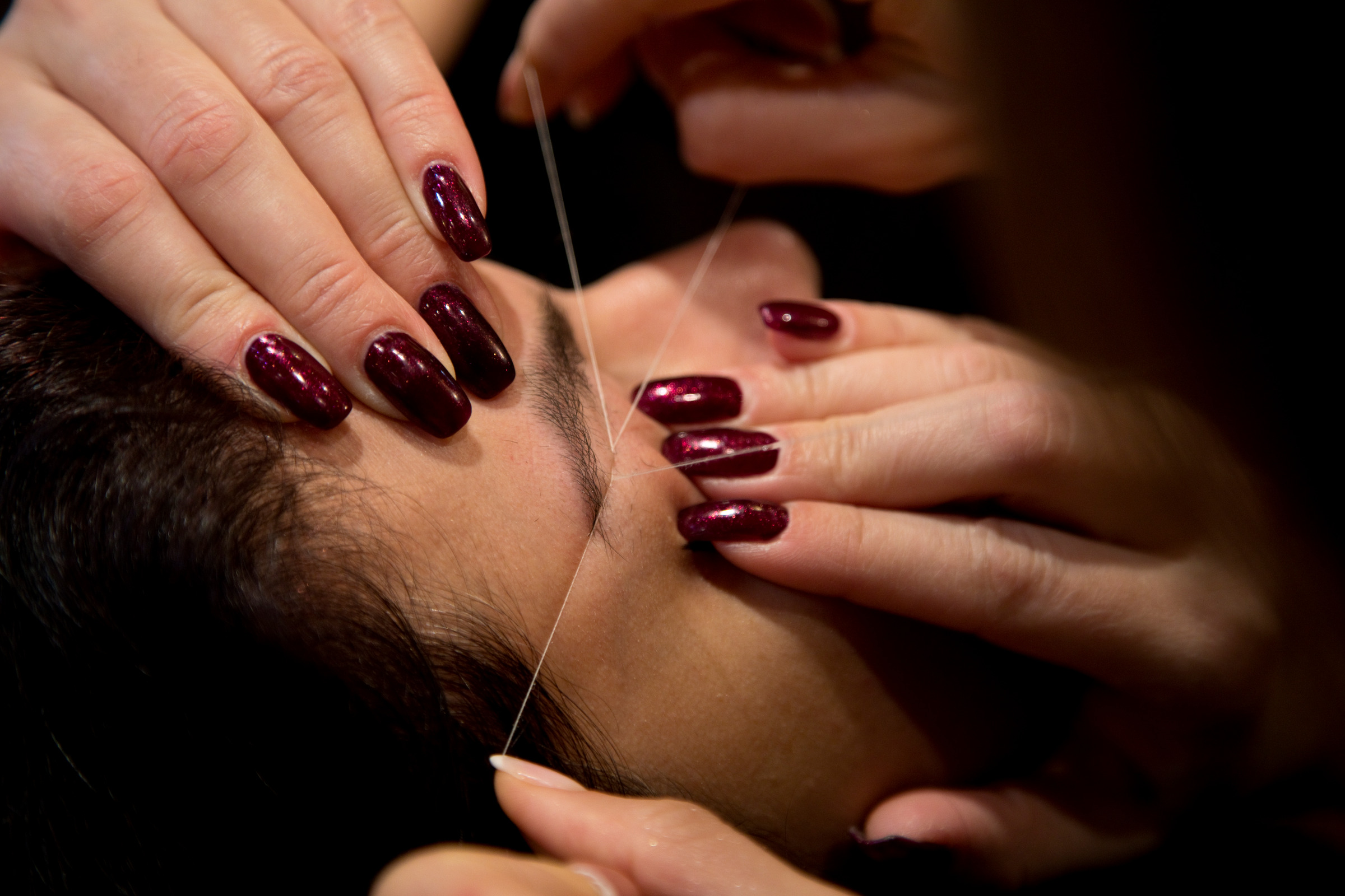 Men's eyebrow threading close-up
