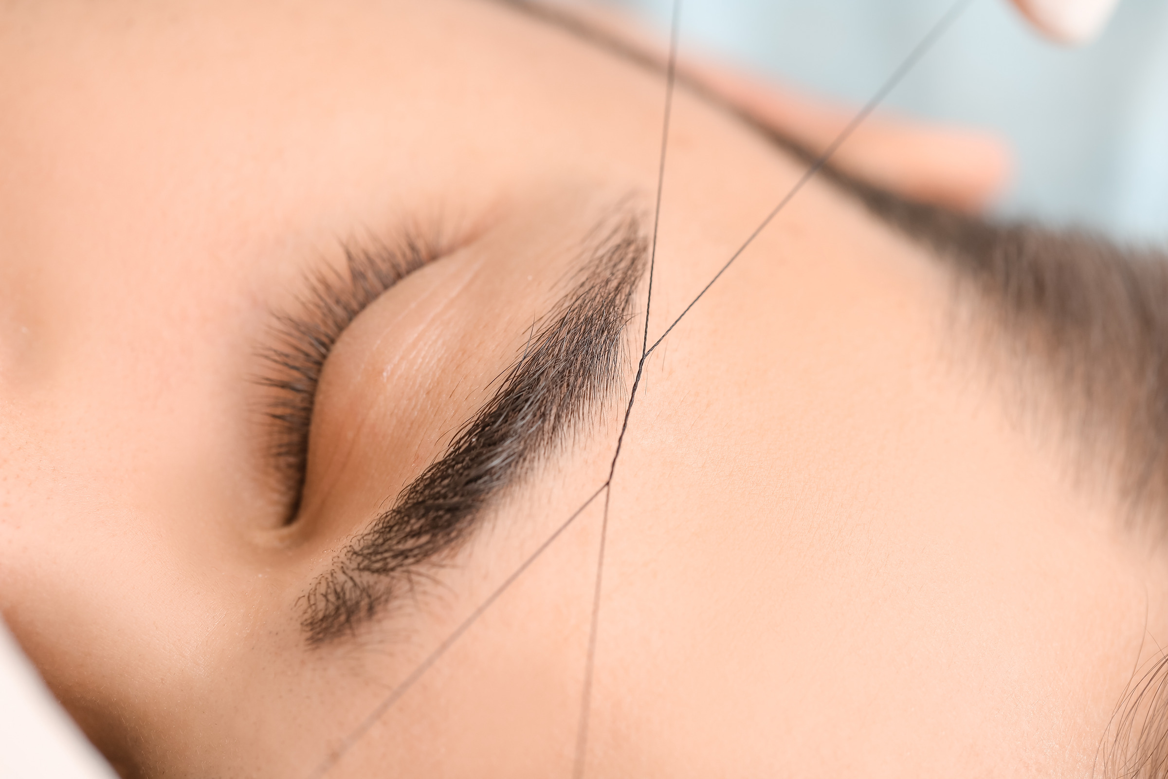 Close-up eyebrow threading